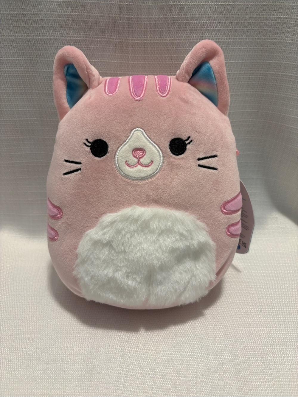 Squishmallows Pink Cat Plush with White Belly and Blue Ear Accents
